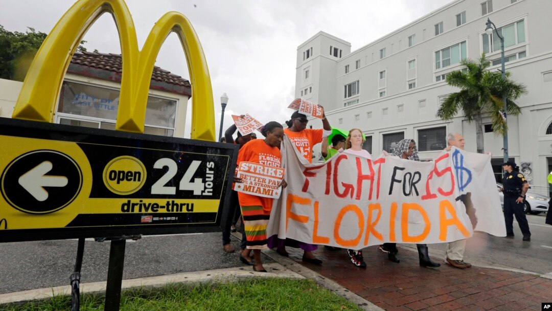 People protest for increased minimum wages outside a McDonald's restaurant in the Little Havana area in Miami, Florida.
