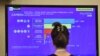 A journalist watches a tv screen showing the first exit polls at the Five Star Movement (M5S) press room early on March 5, 2018 after the closure of the polling stations in Rome. 