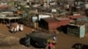A fruit vendor waits for customers at an informal settlement in Thokoza, south of Johannesburg, South Africa, July 18, 2014. 