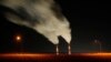 FILE - Smoke rising from the stacks of the La Cygne Generating Station coal-fired power plant in La Cygne, Kansas.