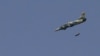 A Syrian Air Force fighter jet launches missiles at El Edaa district in Syria's northwestern city of Aleppo, September 1, 2012.