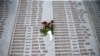FILE - A memorial plaque lists victims' names, in the Srebrenica-Potocari Genocide Memorial Center, Bosnia and Herzegovina, June 8, 2021.