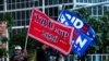 FILE - Supporters of U.S. President Donald Trump and Democratic presidential nominee and former Vice President Joe Biden wave flags of the Perez Art Museum in Miami, Florida, Oct. 5, 2020. 