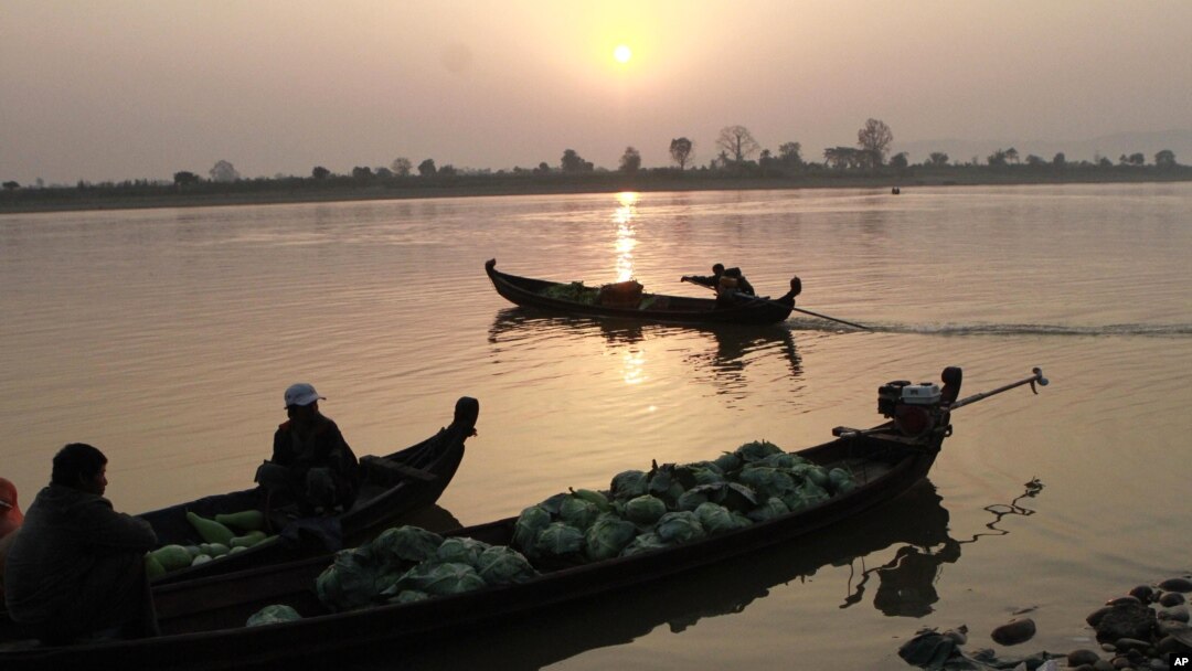 Grocery vendors sit on their boats to cross Irrawaddy river in Myitkyina, February 25, 2012, in Myitkyina, Kachin State, northern Burma.