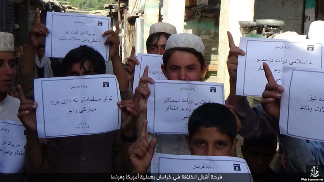FILE - IS social media distributed photos in several languages of children holding placards in Islamic State territories offering "congratulations" on the deaths of Americans, apparently in reference to the Orlando mass shooting on June 12, 2016.