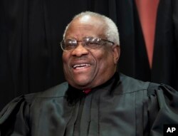 FILE - Associate Justice Clarence Thomas sits with fellow Supreme Court justices for a group portrait at the Supreme Court Building in Washington, Nov. 30, 2018.