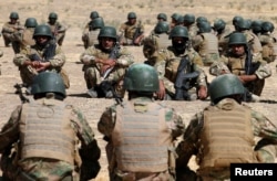 FILE - Fighters from predominantly Sunni Arab force take part in a training session before the upcoming battle to recapture Mosul in Bashiqa, Oct. 6, 2016.