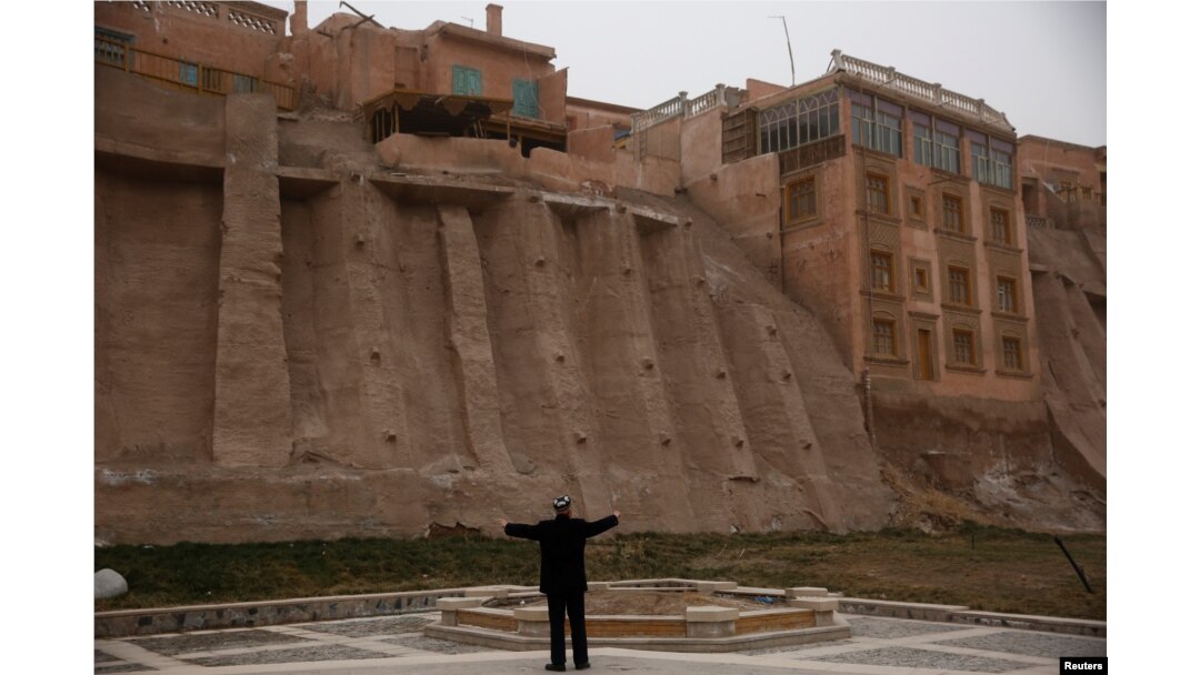 An ethnic Uighur stetches during his morning exercise outside the old town in Kashgar, Xinjiang Uighur Autonomous Region, China, March 23, 2017.