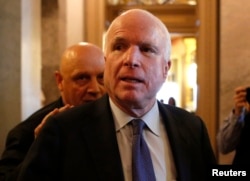FILE - U.S. Senator John McCain (R-AZ) leaves the Senate floor on Capitol Hill, in Washington, Dec. 9, 2014.
