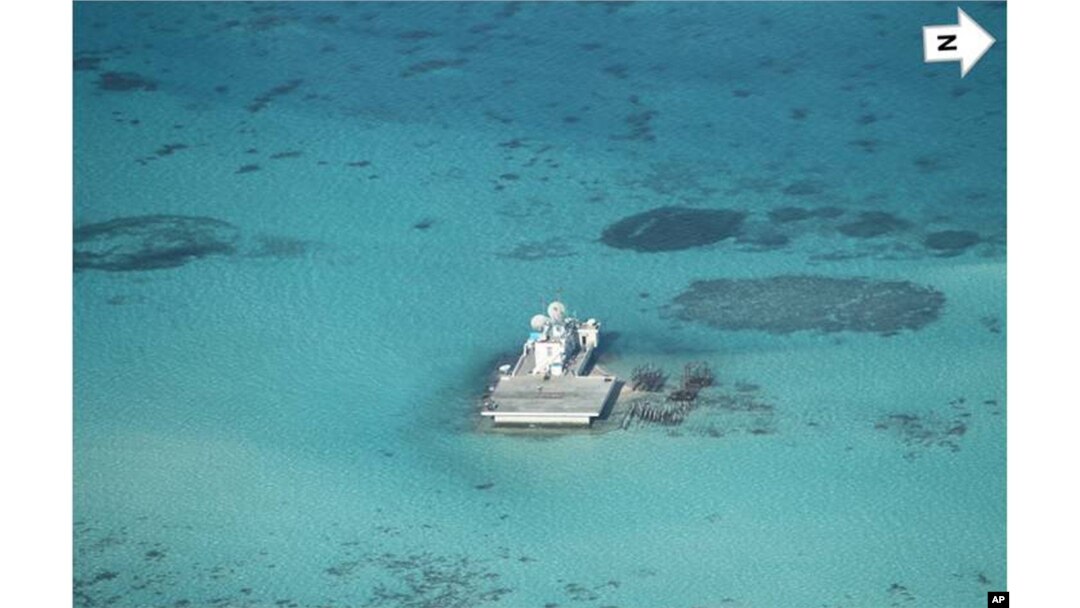 In this photo taken Feb. 28, 2013 by a surveillance plane, and released Thursday, May 15, 2014, by the Philippine Department of Foreign Affairs, Chinese-made structures stands on the Johnson Reef, called Mabini by the Philippines and Chigua by China, in t