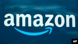 FILE - An Amazon logo appears on a company delivery van, Oct. 1, 2020, in Boston.