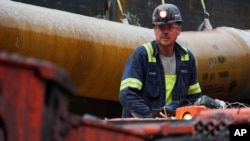 A miner runs a coal continuous miner at a coal mine in Friedens, Pa., June 7, 2017. Corsa Coal Corp. says the mine will create 70 to 100 new jobs and produce some 400,000 tons of metallurgical coal a year.