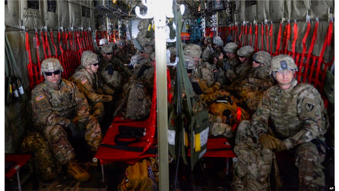 FILE - In this photo provided by the U.S. Air Force, soldiers from the 89th Military Police Brigade, and 41st Engineering Company, 19th Engineering Battalion, Fort Riley, Kansas, arrive at Valley International Airport in Harlingen, Texas, Nov. 1, 2018.
