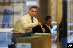 CNN's Jim Acosta goes through security as he enters the federal court building in Washington, Nov. 14, 2018.