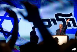 Israel's Prime Minister Benjamin Netanyahu waves during his Likud Party conference in Tel Aviv, Israel, Aug. 9, 2017.