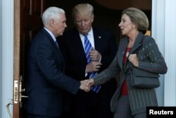 U.S. President-elect Donald Trump and Vice President-elect Mike Pence emerge with Betsy DeVos at Trump National Golf Club in Bedminster, N.J. Nov. 19, 2016. (FILE)