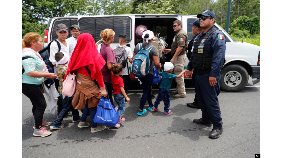Migrants are loaded into a van by Mexican immigration authorities during a raid on a migrant caravan that had earlier crossed the Mexico-Guatemala border, near Metapa, Chiapas state, Mexico, June 5, 2019.