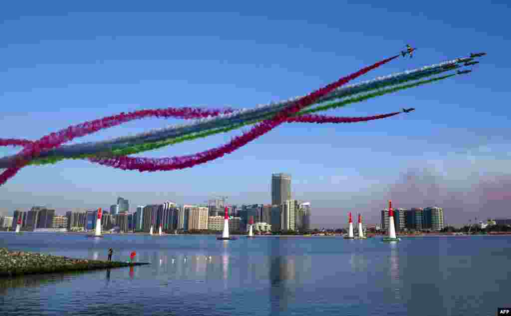 The United Arab Emirates&#39; Al-Fursan (The Knights) National Aerobatic Team performs with smoke with the colors of the UAE flag, during the 2018 Red Bull Air Race World Championship in the Emirati capital Abu Dhabi, Feb. 3, 2018.