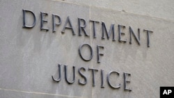 FILE - The outside of the U.S. Department of Justice building in Washington. A U.S. Army soldier was sentenced to 14 years in prison for attempting to help the Islamic State conduct a deadly ambush of U.S. troops, the department said on Friday. 