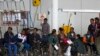 Eritrean refugees wait in a hanger to depart to Sweden. The EU hopes to reduce the number of Eritrean migrants and refugees through aid programs aimed at stabilizing the country.