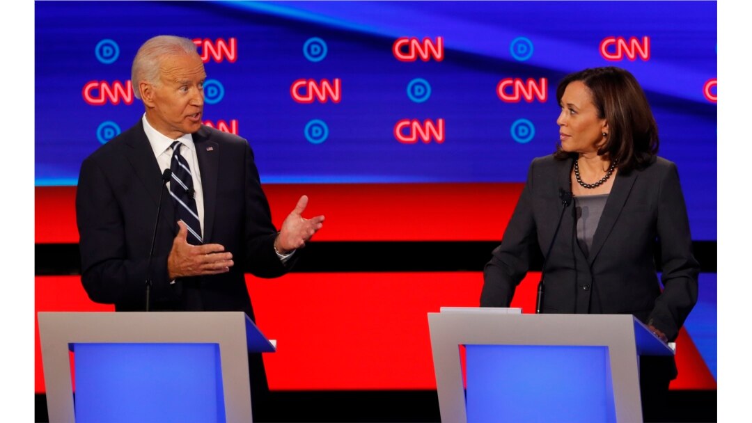 FILE - Sen. Kamala Harris, D-Calif., listens as former Vice President Joe Biden speaks during the second of two Democratic presidential primary debates hosted by CNN, July 31, 2019, in the Fox Theatre in Detroit.