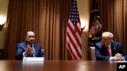 President Donald Trump listens as Robert Unanue, of Goya Foods, speaks during a roundtable meeting with Hispanic leaders in the Cabinet Room, July 9, 2020, in Washington. 