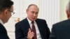 Russian President Vladimir Putin gestures as he speaks during a meeting with opposition candidates who ran against him in the presidential election, at the Kremlin in Moscow, Russia, March 19, 2018.