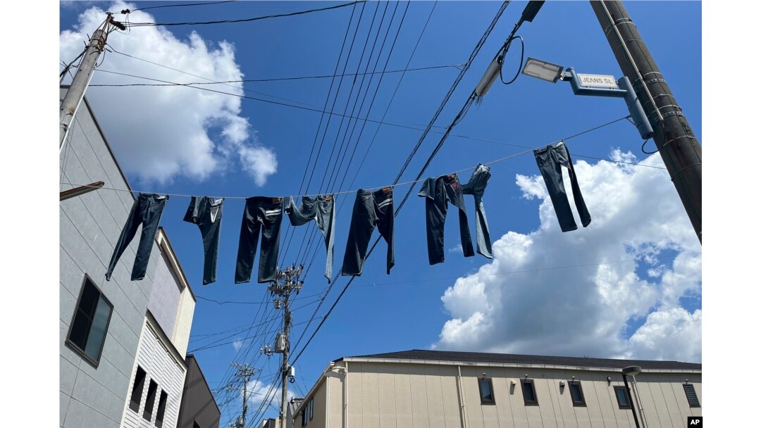 Pairs of jeans flap over Jeans Street in Kojima, Okayama prefecture, Japan, on Sept. 4, 2024. (AP Photo/Yuri Kageyama)