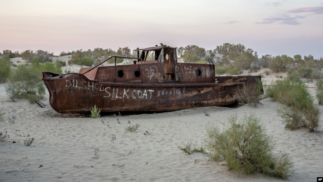 A rusting ship sits in a dried-up area of the Aral Sea in Muynak, Uzbekistan, Sunday, June 25, 2023. (AP Photo/Ebrahim Noroozi)