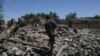An Afghan security police walks at the destroyed house after an operation in Asad Khil near the site of a U.S. bombing in the Achin district of Jalalabad, east of Kabul, Afghanistan, Saturday, April 17, 2017.