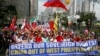 FILE - Protesters march toward the Chinese Consulate, April 9, 2019, in suburban Makati city, Philippines. They are calling on citizens to uphold national sovereignty in the wake of China's alleged occupation of the disputed islands, shoals and reefs in the South China Sea. 