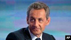 FILE - Former French President Nicolas Sarkozy waits to be interviewed at French TV station TF1 in Boulogne-Billancourt, outside Paris, Aug. 24, 2016. 