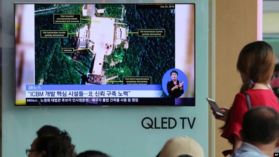 FILE - A TV screen shows a satellite image of a North Korean missile launch site, during a news program at the Seoul Railway Station in Seoul, South Korea, July 24, 2018. 