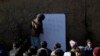 Afghan refugee schoolchildren attend a class at a makeshift school on the outskirts of Islamabad, Pakistan, Dec. 29, 2021. 