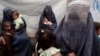Returning Afghan refugees, who have recently arrived from Pakistan, wait during the registration process at a United Nations High Commissioner for Refugees (UNHCR) center on the outskirts of Kabul, Afghanistan, June 20, 2013.