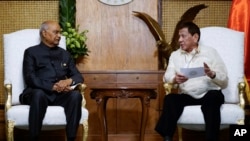 In this photo provided by the Malacanang Presidential Photographers Division, Philippine President Rodrigo Duterte, right, meets with Indian President Ram Nath Kovind during his state visit to Manila, Philippines, Friday, Oct. 18, 2019.