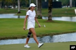 FILE - Kai Trump, granddaughter of former President Donald Trump, walks on the 18th green during the ProAm of the LIV Golf Team Championship at Trump National Doral Golf Club in Florida, Oct. 27, 2022.