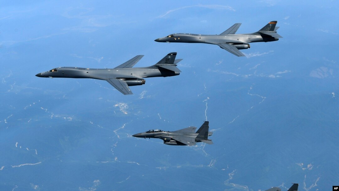 FILE - In this June 20, 2017, file photo provided by South Korean Defense Ministry, U.S. Air Force B-1B bombers, top, and second from top, and South Korean fighter jets F-15K fly over the Korean Peninsula, South Korea. A South Korean lawmaker said Oct. 10, 2017, that North Korean hackers may have stolen highly classified military documents that include U.S.-South Korean wartime "decapitation strike" plans against the North.