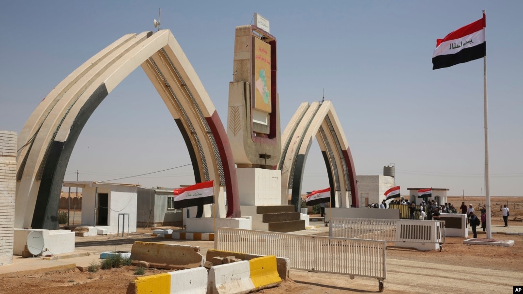 Iraqi flags fly at the recently opened Iraqi Trebil border crossing on the Iraq-Jordan border, Aug. 30, 2017.