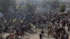 Supporters of religious groups burn tires at a rally to express solidarity with protesters block main highway in capital, Saturday, Nov. 25, 2017 in Peshawar, Pakistan. 