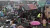 Residents stand among their damaged houses after Typhoon Kammuri hit Legazpi City, Albay, Philippines, December 2, 2019. REUTERS/Nino Luces NO RESALES. NO ARCHIVES
