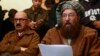 Maulana Sami ul-Haq (R), one of the Taliban negotiators, reads a joint statement with Irfan Siddiqui, a government negotiator, during a news conference in Islamabad, Feb. 6, 2014.