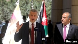 Amman Mayor Yousef Al-Shawarbeh listens to U.N. High Commissioner for Refugees Filippo Grandi as he speaks during the opening of a bazaar to mark World Refugee Day, in Amman, Jordan, June 20, 2019.