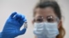 A member of medical staff holds a phial of the Pfizer/BioNTech COVID-19 vaccine jab, at Guy's Hospital, on the first day of the largest immunization programme in the British history, in London, Britain, Dec. 8, 2020.