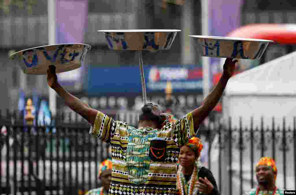 A dancer performs as guests arrive at the Commonwealth Service at Westminster Abbey in London, Britain.