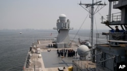 FILE - U.S. Navy sailors gather on the deck of the USS Blue Ridge as it anchors off Manila Bay west of Manila, Philippines, March 13, 2019. The ship's commander renewed an American vow to "sail, fly and operate wherever the law allows us to."