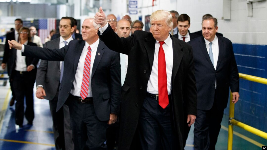 President-elect Donald Trump and Vice President-elect Mike Pence wave as they visit to Carrier factory, Dec. 1, 2016, in Indianapolis, Ind. 