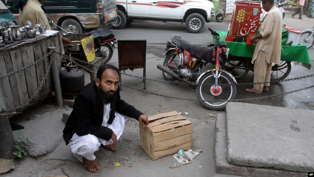 Mustafa Kharal, lawyer of pregnant woman Farzana Parveen who was stoned to death, shows the area where she was killed in Lahore, Pakistan, May 28, 2014