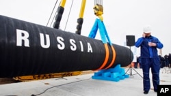 FILE - A Russian construction worker in Portovaya Bay, some 170 km (106 miles) north-west from St. Petersburg, Russia, during a ceremony marking the start of Nord Stream pipeline construction.
