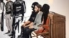 In this courtroom sketch, Salah Abdeslam, right, and Soufiane Ayari, left, appear at the Brussels Justice Palace in Brussels on Monday, Feb. 5, 2018. 